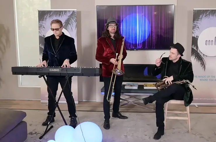 Three members of a jazz band standing with their instruments