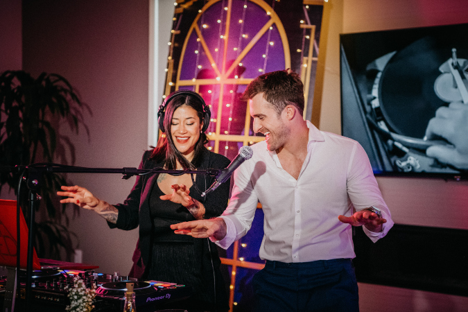 A photo of Matthew Hussey dancing with a DJ