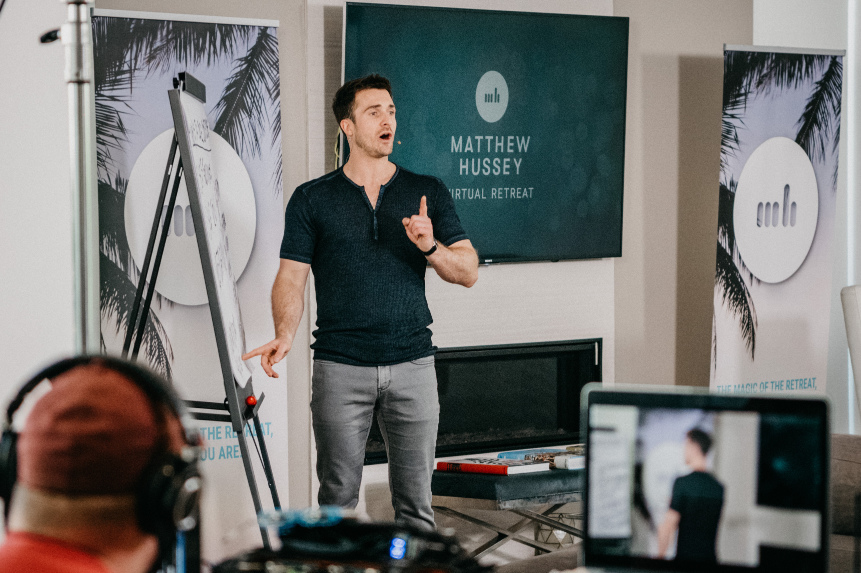 A photo of Matthew Hussey pointing at an easel pad