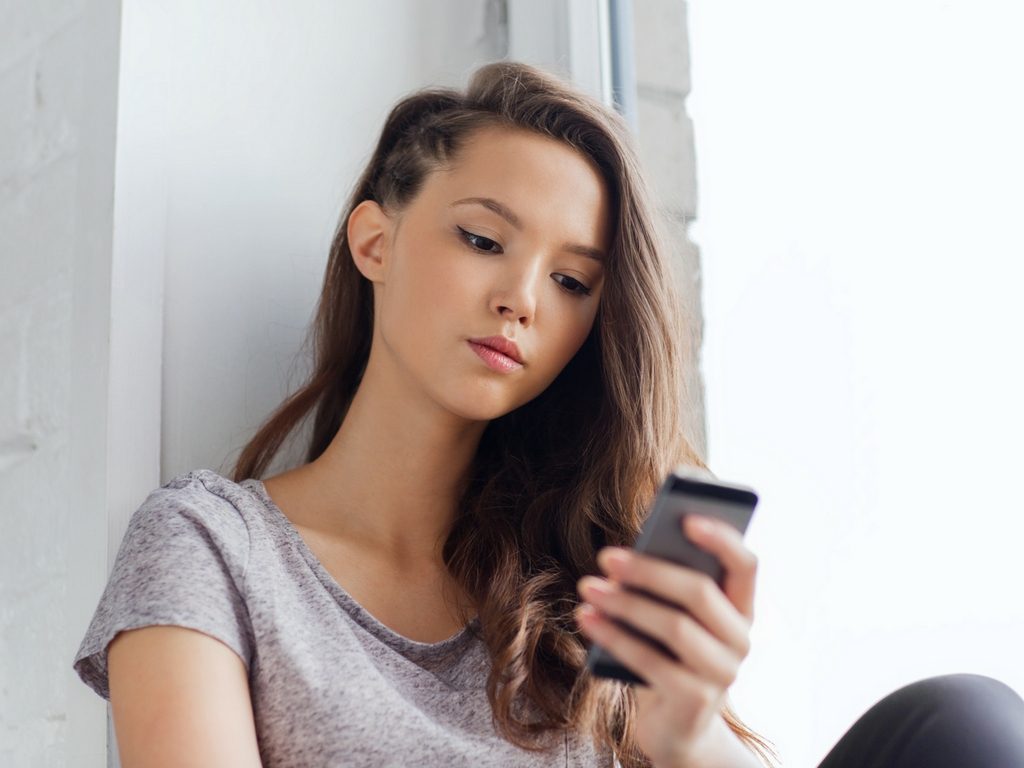 woman looking at her phone