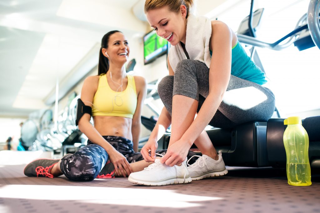 women smiling at the gym