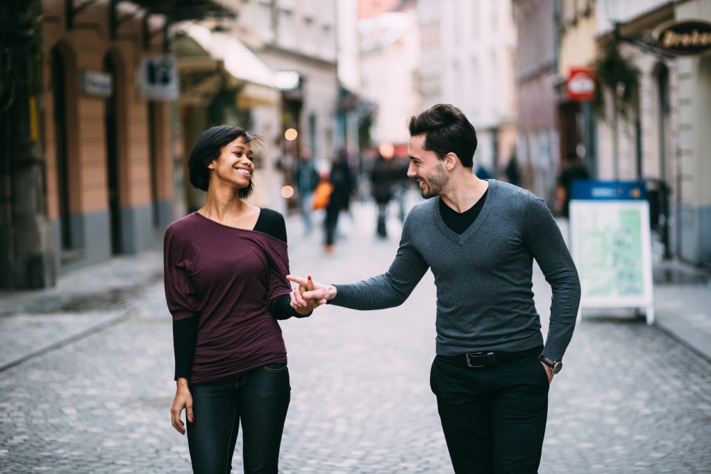 couple holding hands on the street